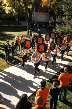 Sousaphones lead the Syracuse University Marching Band from around the back of Hendricks chapel as they enter onto the stairs for the quad show. The brass and woodwind sections of the band entered as the drumline played “Street Time”, one of their many cadences. 