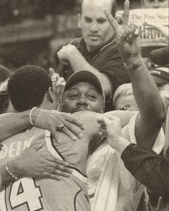 After the championship game on April 7, 2003, William Edelin gestures to the crowd while embracing his son Billy, whose play off the bench again sparked SU.