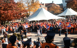 Crowds of people, both Syracuse and Notre Dame fans, fill the lawn of the quad as the marching band performs. With the sold out game, the crowd was larger than a normal quad show. 
