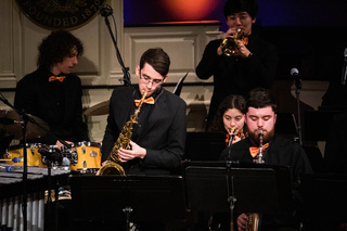 Sophomore Joe King performs a solo on the tenor saxophone during a jazz ensemble performance at Holidays at Hendricks. The jazz ensemble was one of several groups to share their music with the audience. 