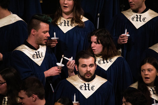 Members of the Hendricks Chapel Choir light candles as they sing. The candles were held by every person in attendance that was able. 