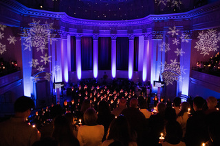The chapel goes dark except for the light of the candles and the blue uplighting behind the performers as they sing “Silent Night” by Frank Sinatra. With a sold out audience, the chapel was still well lit by all of the people as they held their candles. 