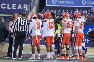  Four members of the SU football team meet Minnesota’s players at the center of the field for the coin toss to decide who gets possession of the ball first. SU lineback Marlowe Wax Jr., defensive lineman Caleb Okechukwu and offensive linemen Carlos Vettorello and Dakota Davis are the four chosen for the toss. 