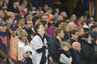 Fans anxiously watch the game as Minnesota intercepted and ran the ball. Syracuse fans filled most of Yankee Stadium, creating a sea of orange on the left side of the scoreboard. 
