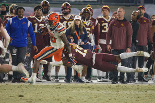 Senior defensive back Isaiah Johnson runs the ball toward the end zone as a Minnesota player leaps in to attempt a tackle. Johnson made six total tackles and four solo tackles during the game bringing him to 47 tackles for the year. 