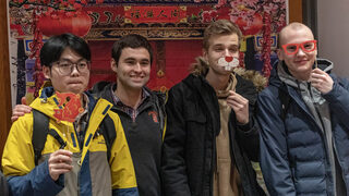 Students pose at a photo booth set-up with fun Lunar New Year themed accessories. 2023 is the year of the rabbit, so rabbit accessories were among the pile to choose from. 