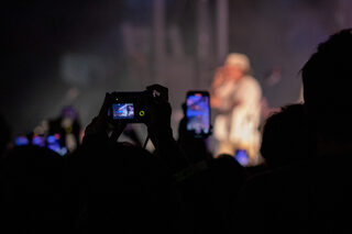 Audience members document the show in different ways, whether it be a cellphone or a digital camera. Students crammed toward the front of the stage, danced on the outskirts of the floor and enjoyed the music from seats in the stands.
