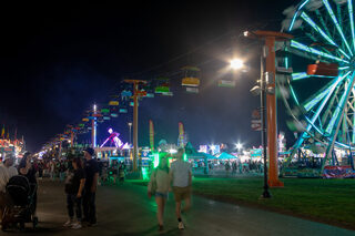 Lights from the rides and food stalls illuminate the paths of the Midway as the crowds start to dissipate. The sweet treat locations were the busiest locations at the end of the night as people looked to satisfy their sweet tooth before heading home. 
