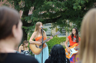 Bella Fiske, a Communication & Rhetorical Studies freshman, takes a college stage for the second time after making her Syracuse debut at house venue The Mudpit. The music gradually attracted more people to the Quad as bands continued to play.

Correction: A previous version of this article stated that Bella Fiske was a Bandier Freshman. This was incorrect; Bella Fiske is actually a Communication and Rhetorical Studies Freshman. The Daily Orange regrets this error. Updated September 12, 11:21am.