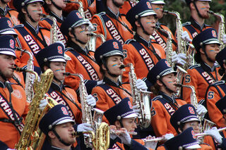 Saxophonists showcase their unified school spirit by painting orange and blue stripes on their cheeks. They played “Bohemian Rhapsody” as well as the SU Fight Song that is also chanted at football games.